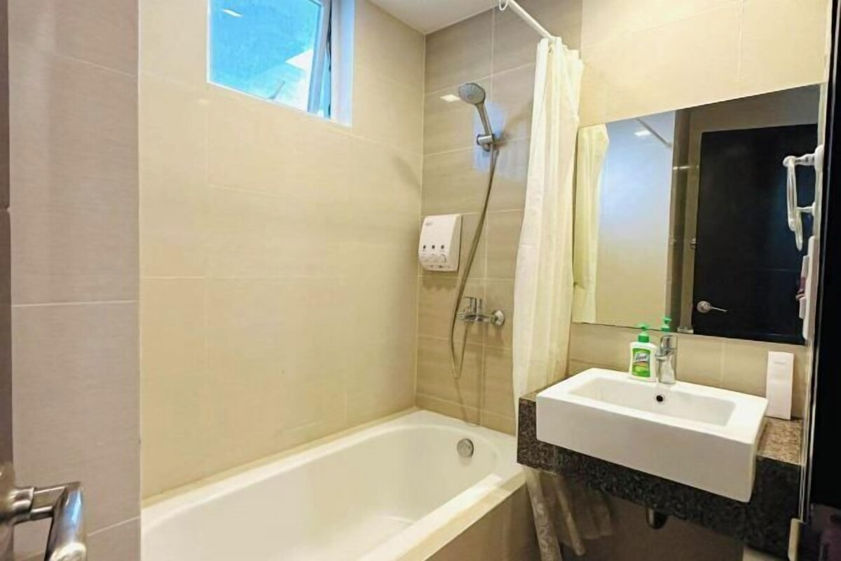 A bathroom with a bathtub, a shower, a sink, and a mirror.