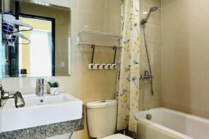 A bathroom with a sink, toilet, and bathtub. - One Pacific Place by Hiverooms (Lapu-Lapu City)