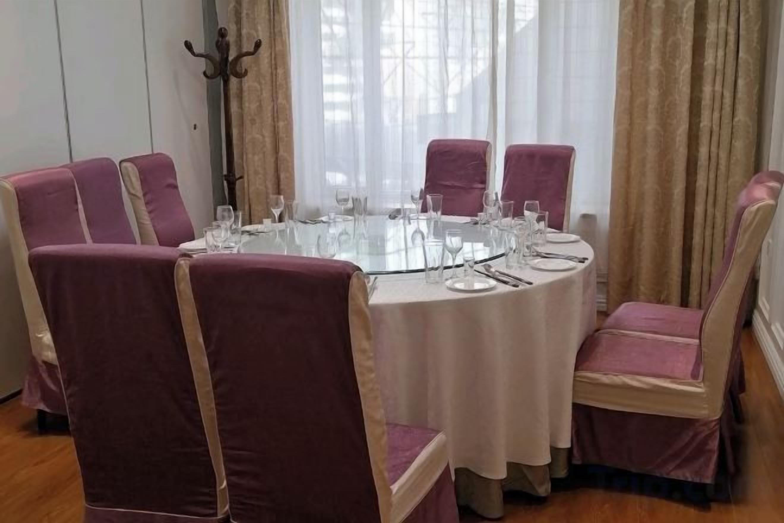 Un tavolo rotondo con sedie, apparecchiato per un pasto.