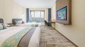 A hotel room with two beds, a desk, a chair, a TV, and a large window with a city view. - Friendly Hotel (Meimei Shopping Center Autonomous Region Museum Branch) (Urumqi)