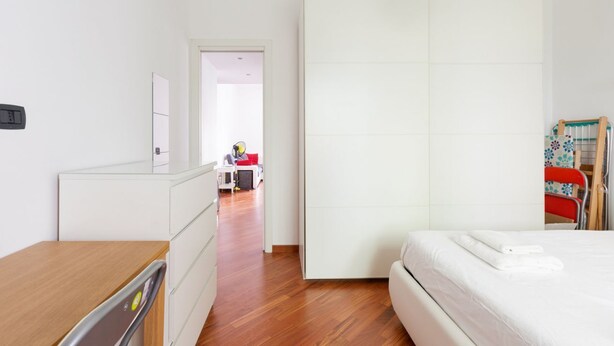 A bedroom with a bed, a dresser, a wardrobe, and a desk. - GuestHost - Cà Granda M5 & Bicocca - Apartment Cosy (Milano)