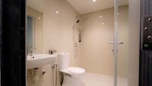 A modern bathroom with a toilet, sink, and shower. - T Hotel Jalan Sultanah (Alor Setar)