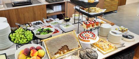 A buffet with various food items and dishes.