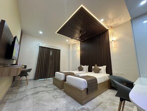 A modern hotel room with a large bed, a desk, and a TV. - Silver Stone Park Resort (Nagpur)