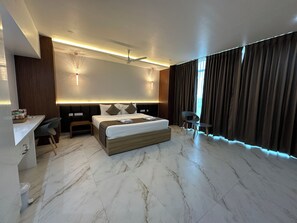 A modern hotel room with a large bed, a desk, and a chair. - Silver Stone Park Resort (Nagpur)