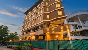A multi-story hotel with a modern design, featuring a prominent 'Fabexpress' sign on the ground floor. - Via Sunset Residency (Navi Mumbai)