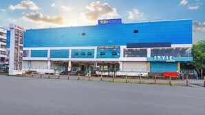 A modern hotel building with a prominent 'fab hotels' sign, a 'hotel embassy' section, and a 'style' store on the ground floor. - FabHotel Embassy (Pune)