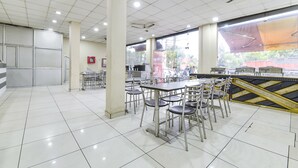 A spacious cafeteria with high ceilings, ample lighting, and a view of the outdoors. - Fabexpress Perfect (Samba)