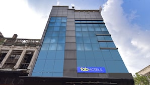 A tall building with a modern facade and a sign reading "fab hotels". - Fabexpress Glacier Inn (Jammu)