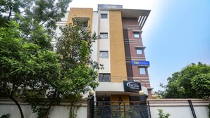 A multi-story hotel with a modern facade, a gated entrance, and a sign for 'Gayatri Hotel'. - Fabhotel Gayatri Inn Annex (Nagpur)