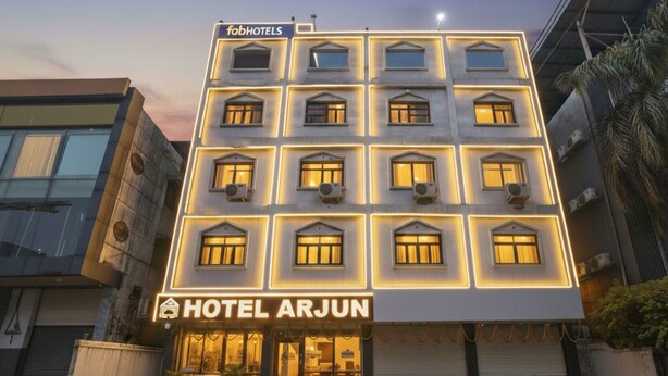 A multi-story hotel with a modern facade, featuring a prominent sign for 'Hotel Arjun' and 'FabHotels'. - Fabhotel Arjun (Nagpur)