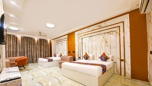 A hotel room with two beds, a sofa, a TV, and a marble floor. - Fabhotel Royal'S Paradise (Faridabad)