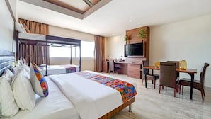 A hotel room with a large bed, a desk, a chair, and a television. - Oriva Nestlay Rooms Ramnad (Ramanathapuram)
