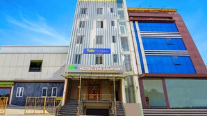 A modern hotel facade with a prominent 'fab-hotels' sign, a 'Status by Hotel The Emporio' sign, and a 'SBB' logo. - Fabhotel Prime Emporio Villa By Sbg (Ghaziabad)