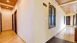 A hallway with a marble floor, wooden ceiling, and a sign indicating the first floor. - Fabhotel Lali Palace (Udaipur)