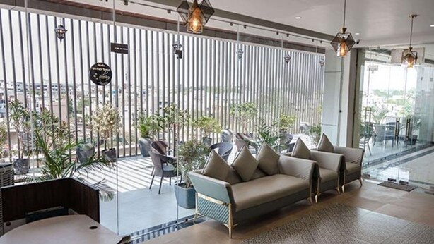 A modern lounge area with a sofa, chairs, and a coffee table. - Fabhotel Prime Lavkush (Raipur)