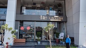 A hotel entrance with a modern design, featuring a glass facade and a sign that reads "HL LAVKUSH." - Fabhotel Prime Lavkush (Raipur)