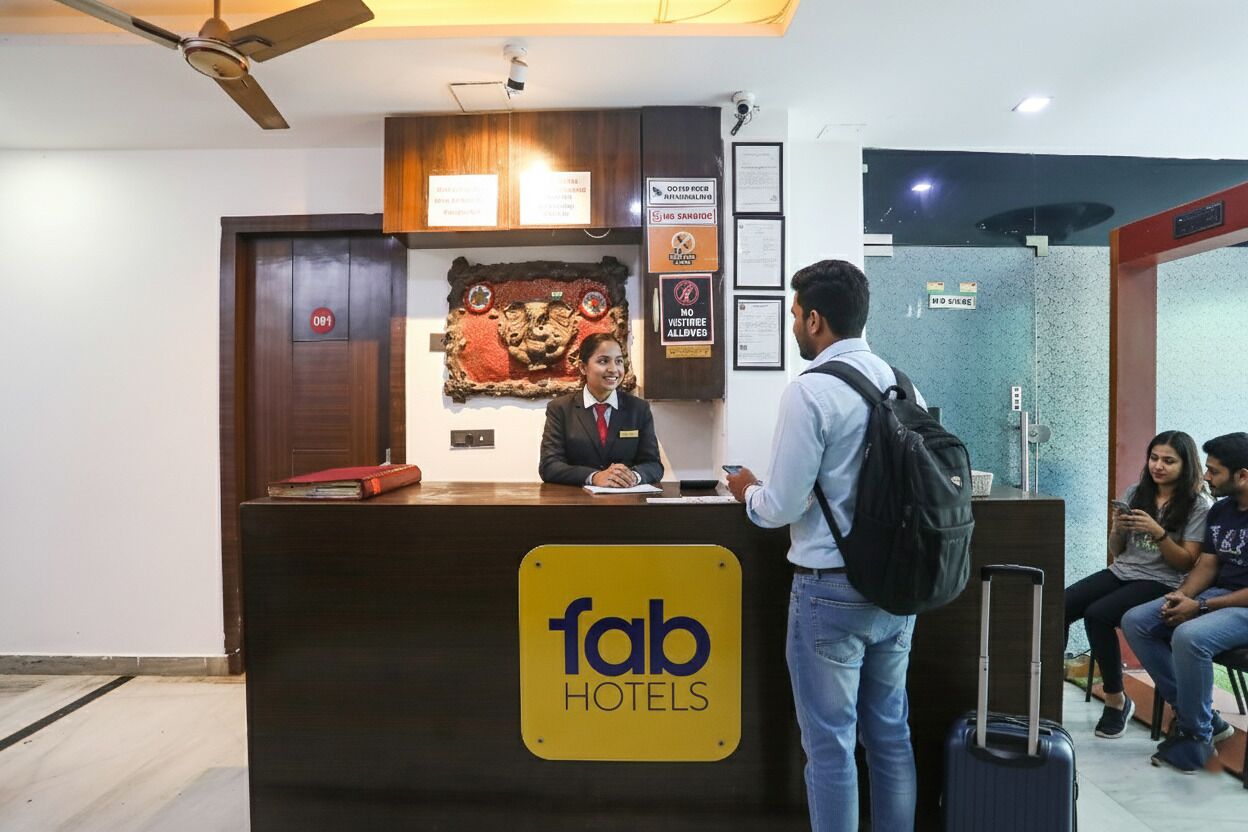 Un comptoir d’accueil avec une pancarte indiquant « fab hotels ».