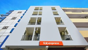 A multi-story building with a prominent 'fabexpress' sign at the ground level. - FabHotel Twamev (New Delhi)