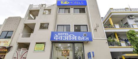 A multi-story building with a prominent 'fab hotels' sign above the entrance.