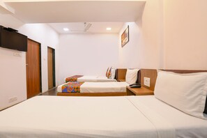 A hotel room with two beds, a ceiling fan, a TV, and a painting on the wall. - FabHotel Aksa Inn (Mumbai)