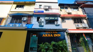 A building with a sign for "Hotel Aksa Inn" and multiple air conditioning units. - FabHotel Aksa Inn (Mumbai)