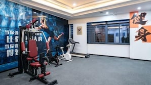 A gym with exercise equipment, a treadmill, and a wall with motivational text. - Manju Hotel (Shaoxing)