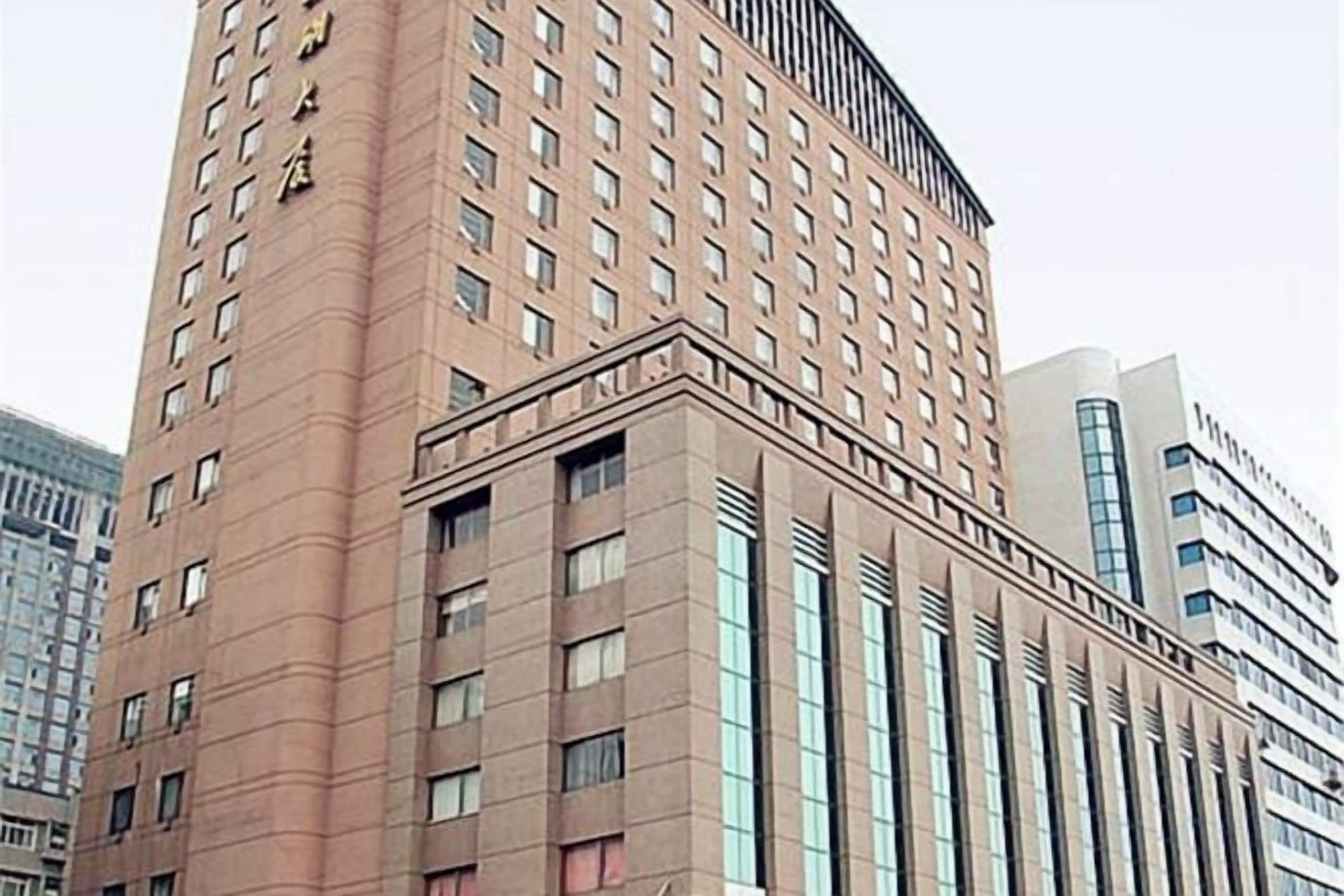 A multi-story building with a prominent corner entrance and large windows.
