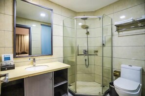 A bathroom with a glass-enclosed shower, a sink, a toilet, and a mirror. - Manzhou Hotel (Yongshun Yinhe Branch) (Yongshun)