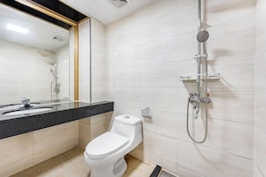 A modern bathroom with a toilet, sink, and shower. - Junxing hotel (Yingde)