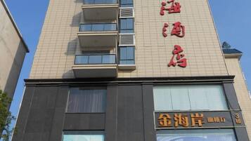 A hotel with a sign indicating it is a hotel and a restaurant named '金海岸'.