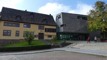 A building with a traditional facade and a modern extension.