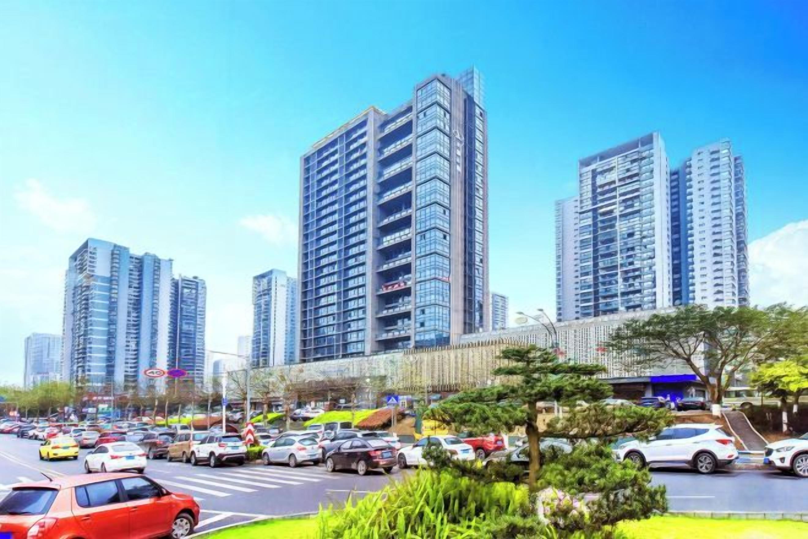 Una calle urbana con edificios altos, un paso de peatones y automóviles.