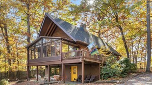 A cabin with a balcony, a porch, and a deck. - Log Cabin w/ Hot Tub & Waterfront Patio! (Harpers Ferry)