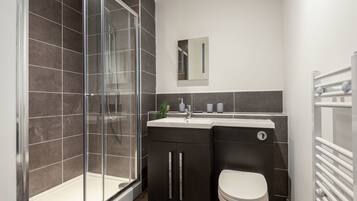 Shower, hair dryer, towels, shampoo