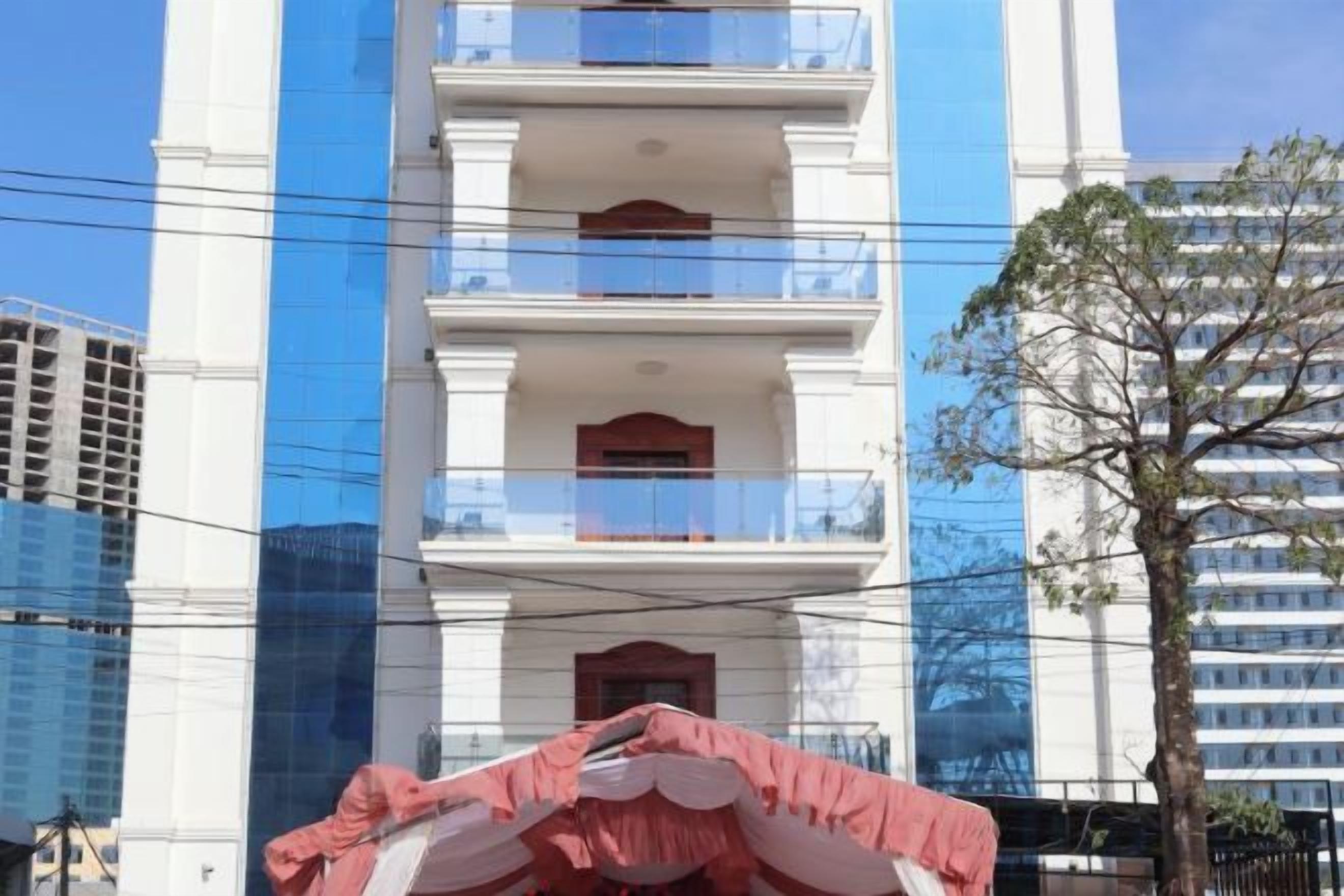 A multi-story building with balconies and a clear sky.