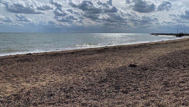 A beach with pebbles, a pier, and a cloudy sky. - GC132 - Discover Your Perfect Seaside Escape in Clacton-on-Sea! (Saint Osyth)