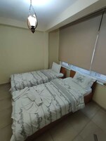 Economy Room | Minibar, bed sheets