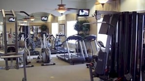 A gym with various exercise equipment including treadmills, stationary bikes, and weight machines. - ⭐ Stunning 6 Bed 5 bath Villa | 4 King Ensuite's | Private Pool | Gated Resort ⭐ (Davenport)