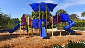 A playground with a blue slide, a red and yellow climbing structure, and a canopy. - ⭐ Stunning 6 Bed 5 bath Villa | 4 King Ensuite's | Private Pool | Gated Resort ⭐ (Davenport)
