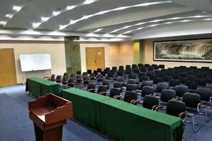 A conference room with rows of chairs, a podium, and a whiteboard. - Silver Spring Hotel (Shenzhen Yuanling Subway Station) (Shenzhen)