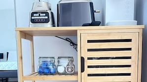 A wooden shelf unit with a blender, toaster, and coffee maker on top. - LR2 Bay Tree great studio + pool in Little River (Little River)
