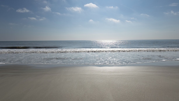 A beach with a clear sky and calm sea. - 891 Ketch Court @ Harbour Town, Sea Pines | Walk to Marina & Golf Links | Pet-Friendly! (Hilton Head Island)
