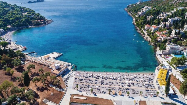 A coastal town with a beach, boats, and buildings along the shore. - Apartment Nature View near Dubrovnik (Zupa dubrovacka)