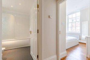A bathroom with a bathtub, a toilet, and a shower.