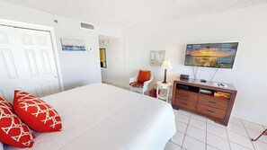 A hotel room with a bed, a television, a wooden dresser, and a chair. - Islander Beach Resort 302 Gulf Front Studio (Fort Walton Beach)