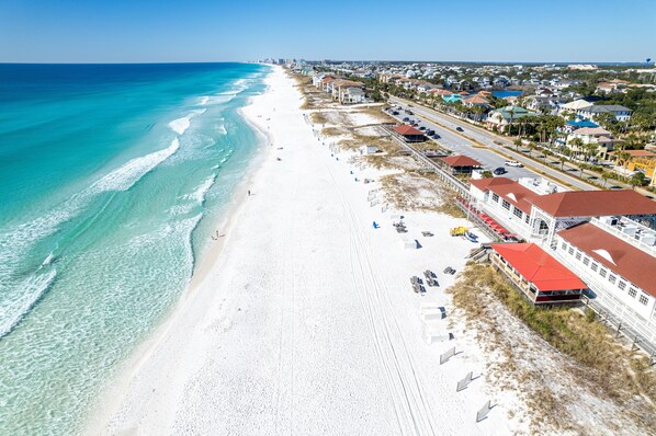 A coastal hotel with a beach view, multiple rooms, and a parking area. - Spacious Home in Destiny West (Destin)