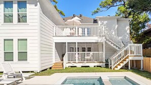 A two-story house with a balcony, a covered porch, and a swimming pool. - Resort-Style 3BR/3BA • Pool & Spa • Gated (Houston)