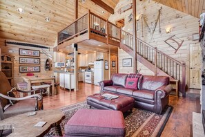 Relax in this cabin with a living area, kitchen, and balcony offering a view of the surrounding landscape.