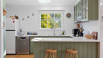 Dishwasher, coffee/tea maker, cookware/dishes/utensils, dining tables